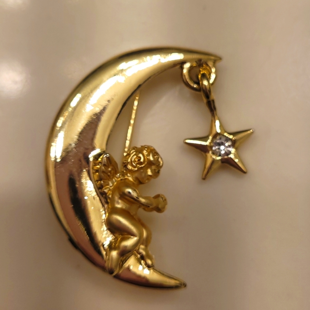 L Razza Rhinestone goldtone moon and star brooch.